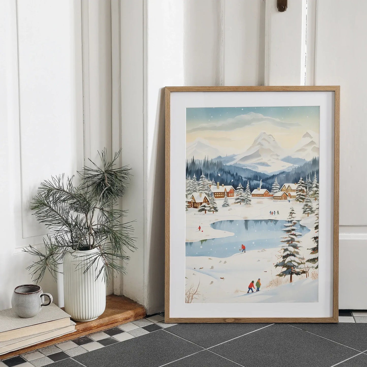 Winter Village Christmas Art Print showcased in a cozy home setting, capturing festive winter charm and snowy landscape.