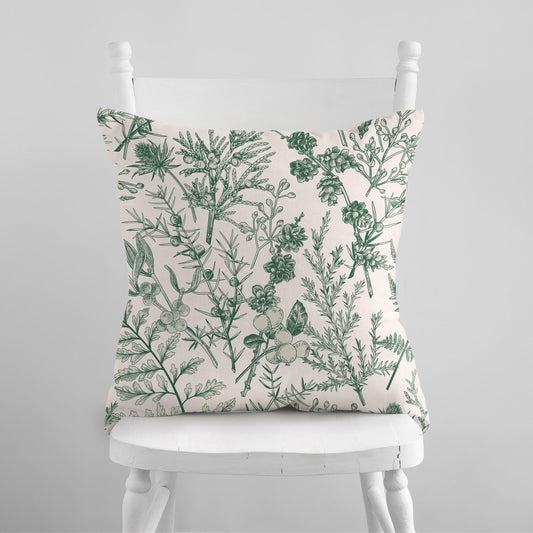 white chair with Vintage Green Winter Botanical PILLOW from Blue Water Songs on it