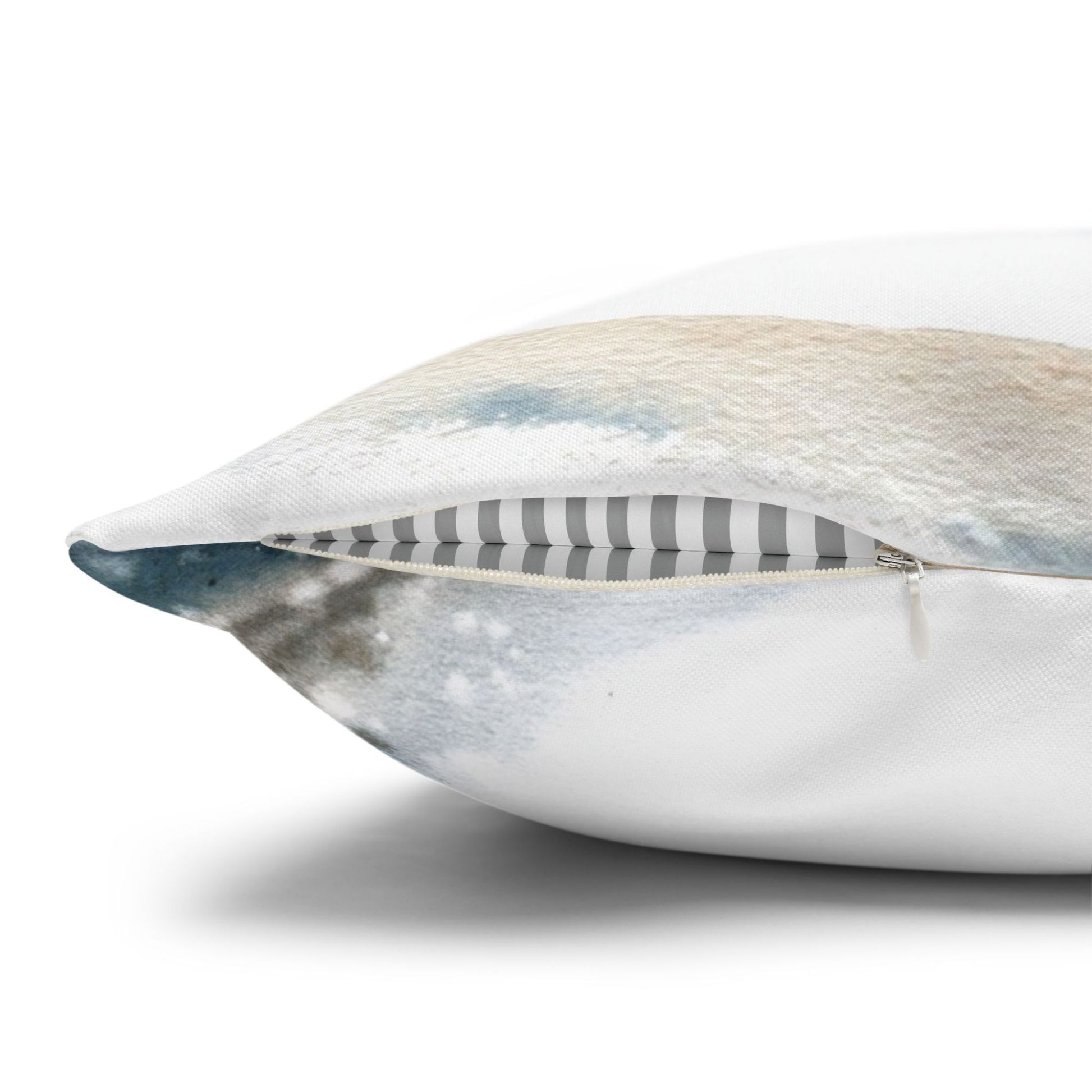 Close-up of hidden zipper on watercolor winter pillow – striped inner lining and snowy painted fabric