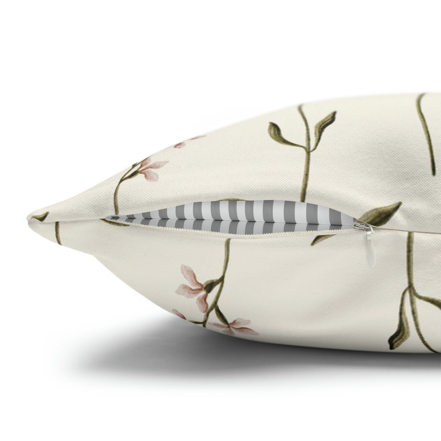 a white pillow with a floral design on it