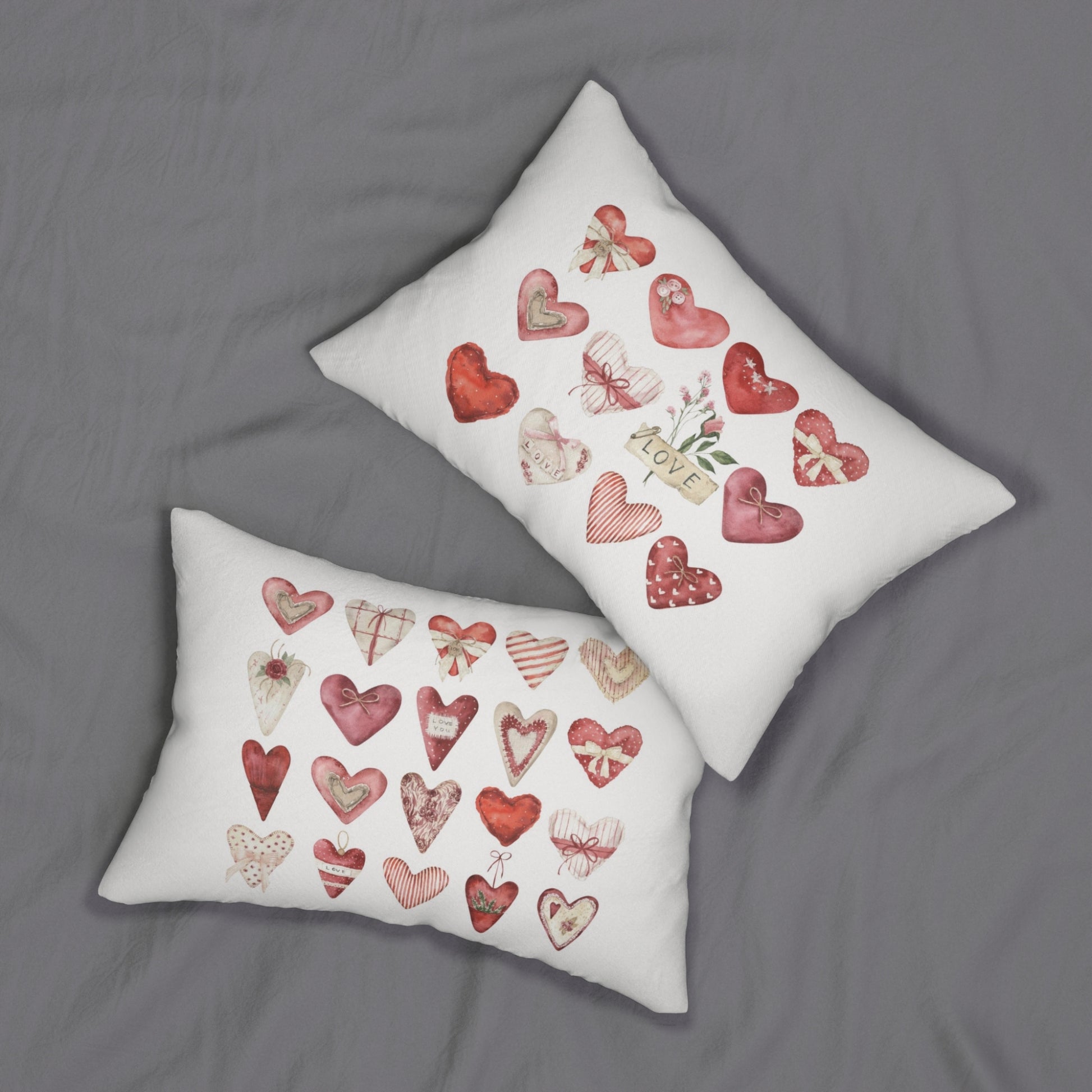 two pillows with hearts on them on a bed