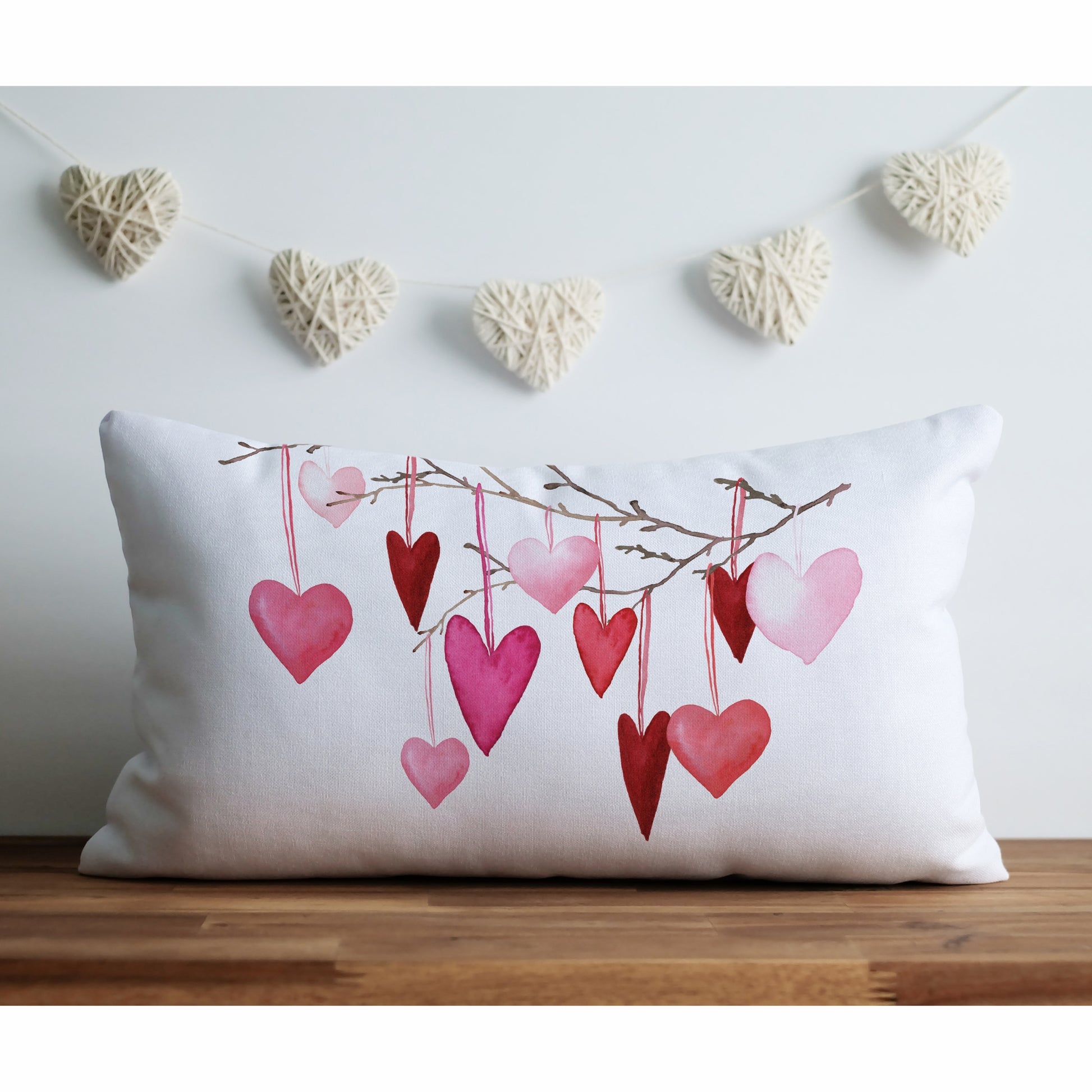 a white pillow with hearts hanging from it