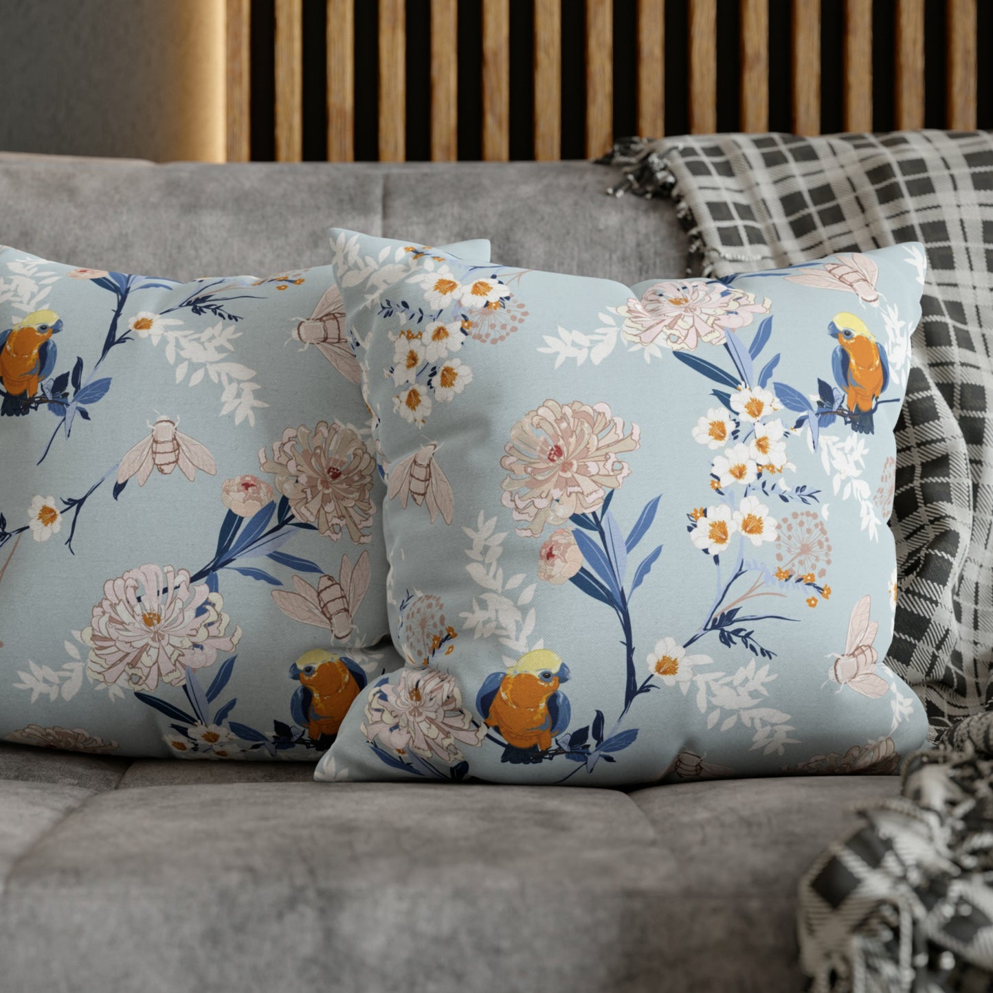 two pillows on a couch with a plaid pillow