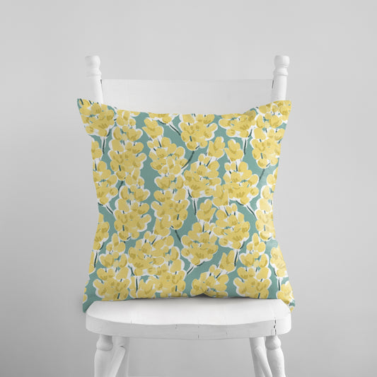 a white chair with a yellow pillow on it