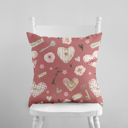 a pink pillow with hearts and keys on it