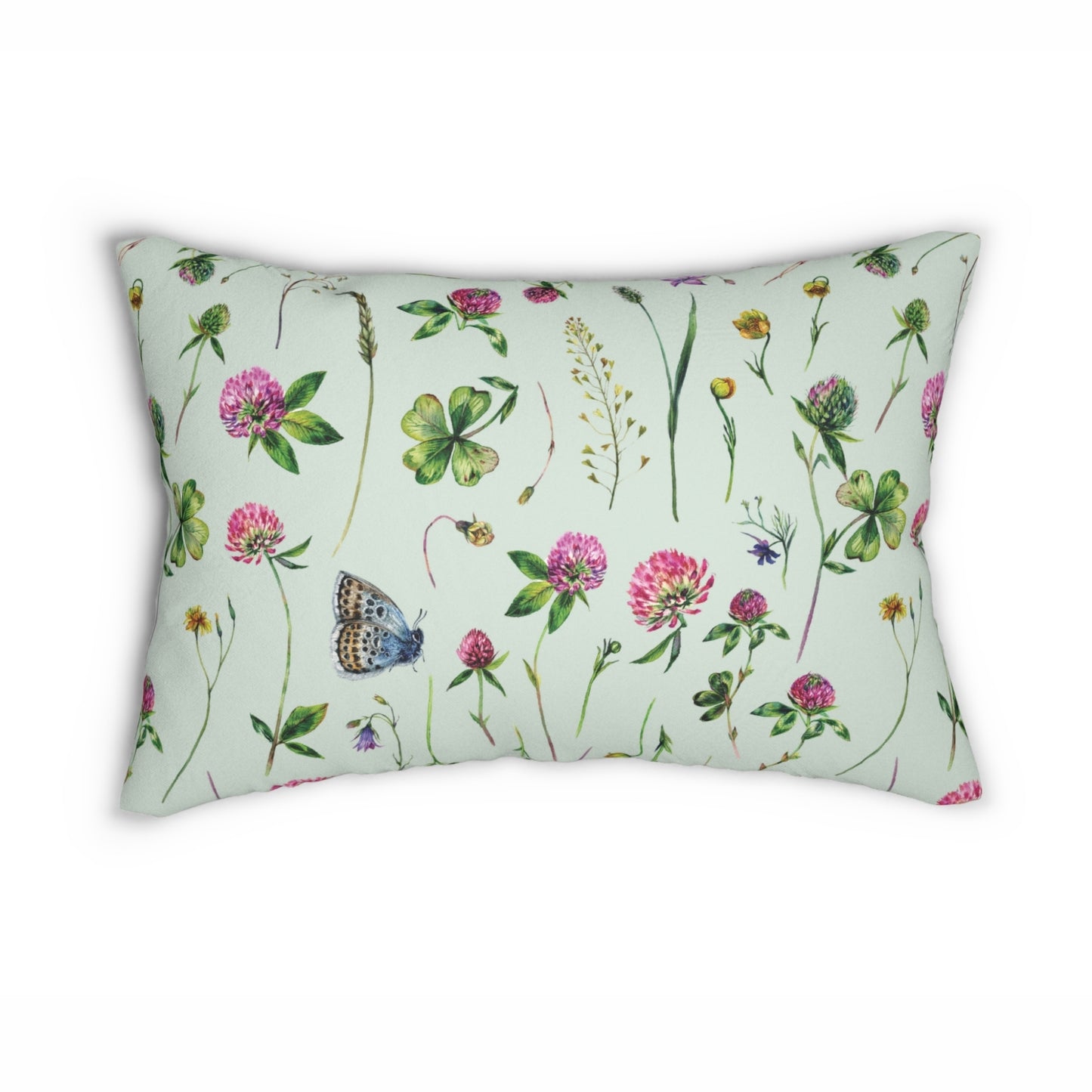 a green pillow with flowers and butterflies on it