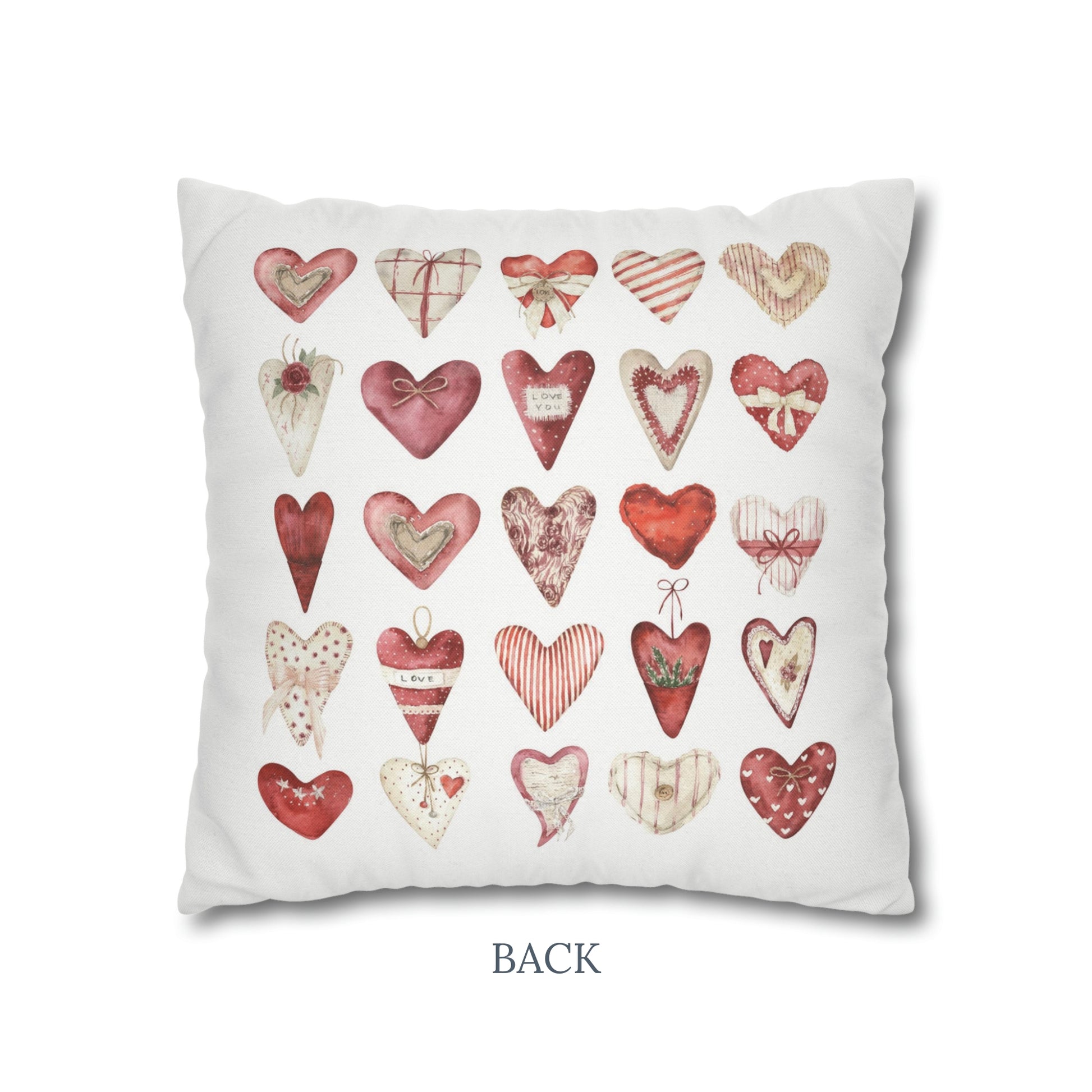 a white pillow with a bunch of hearts on it