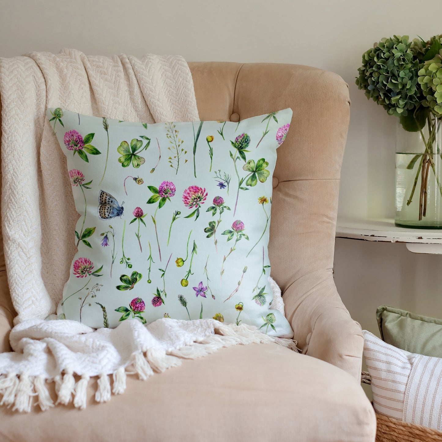 a chair with a pillow and a blanket on it