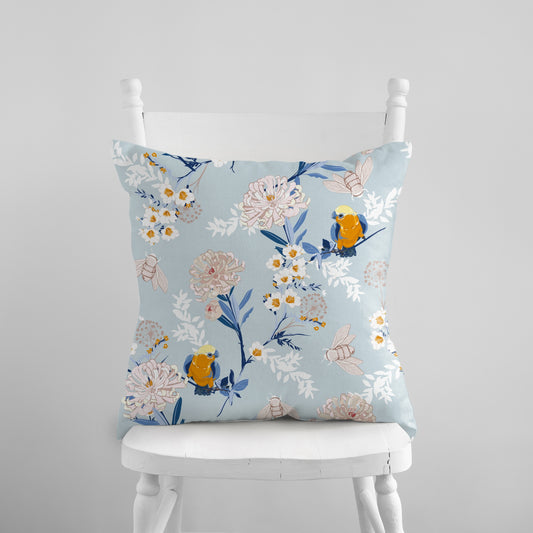 a white chair with a blue floral pillow on it