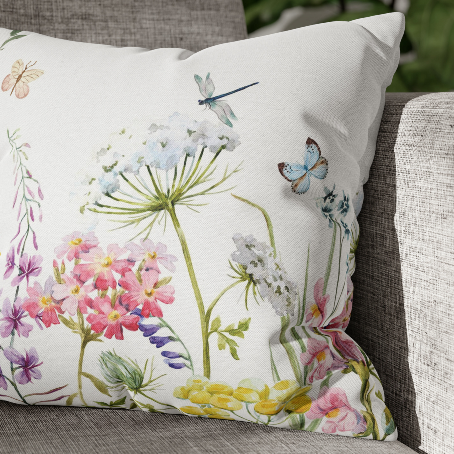 a white pillow with colorful flowers and butterflies on it