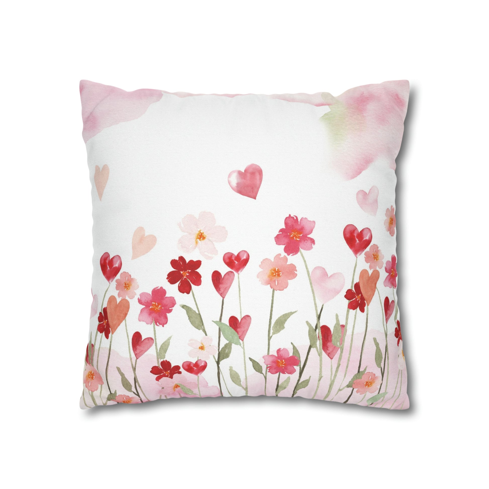a white pillow with pink and red flowers on it