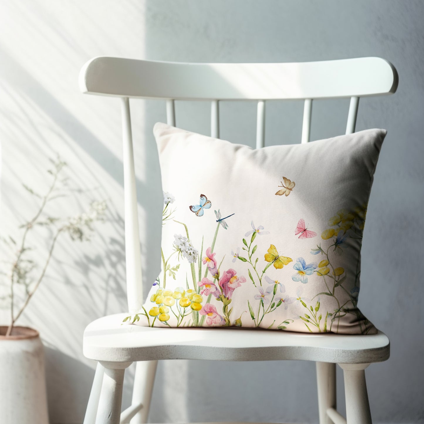 a white chair sitting next to a white wall