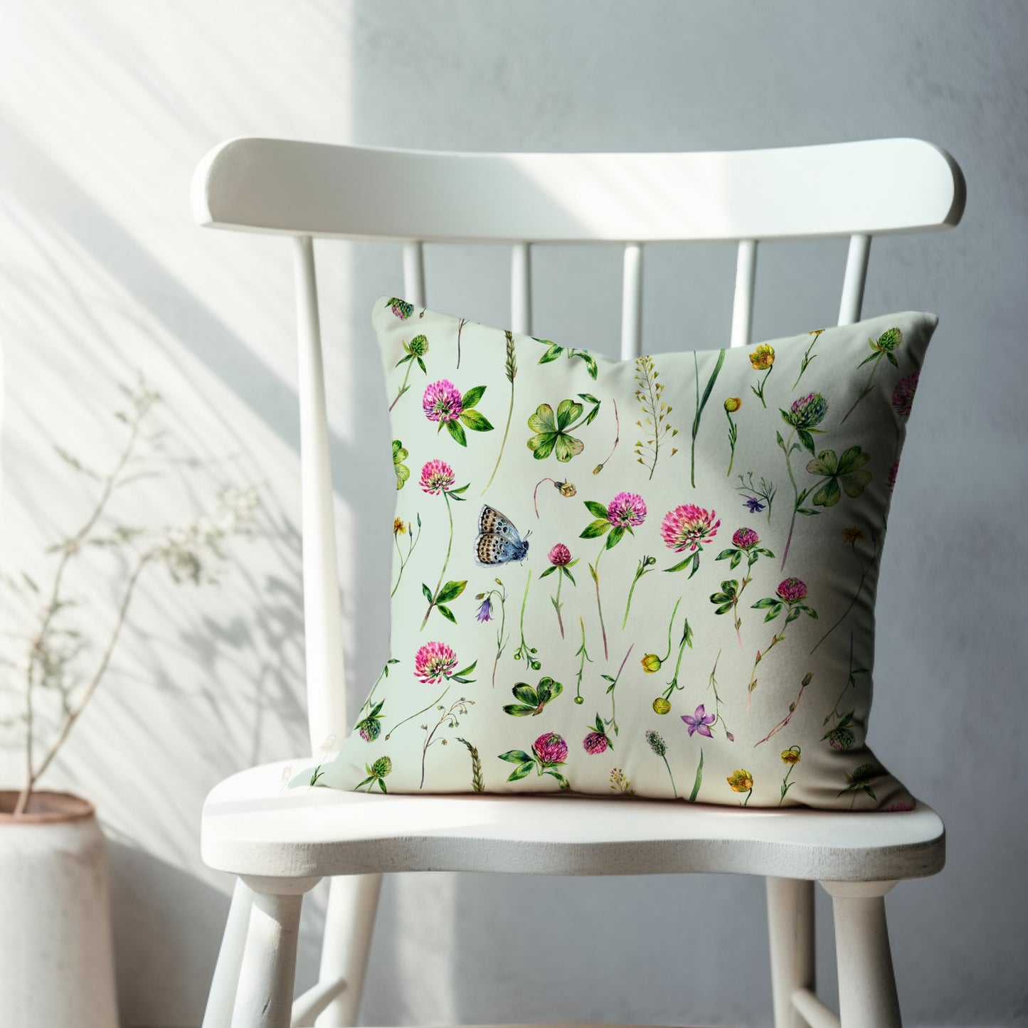 a white chair sitting next to a white wall