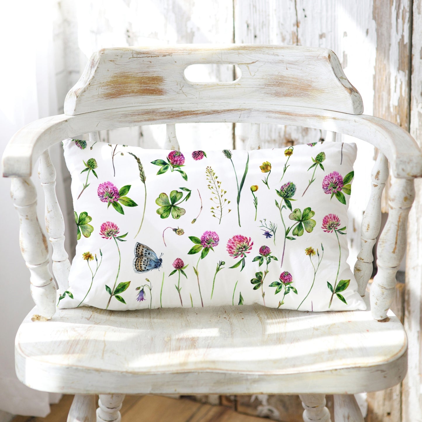 a white bench with a pillow on top of it