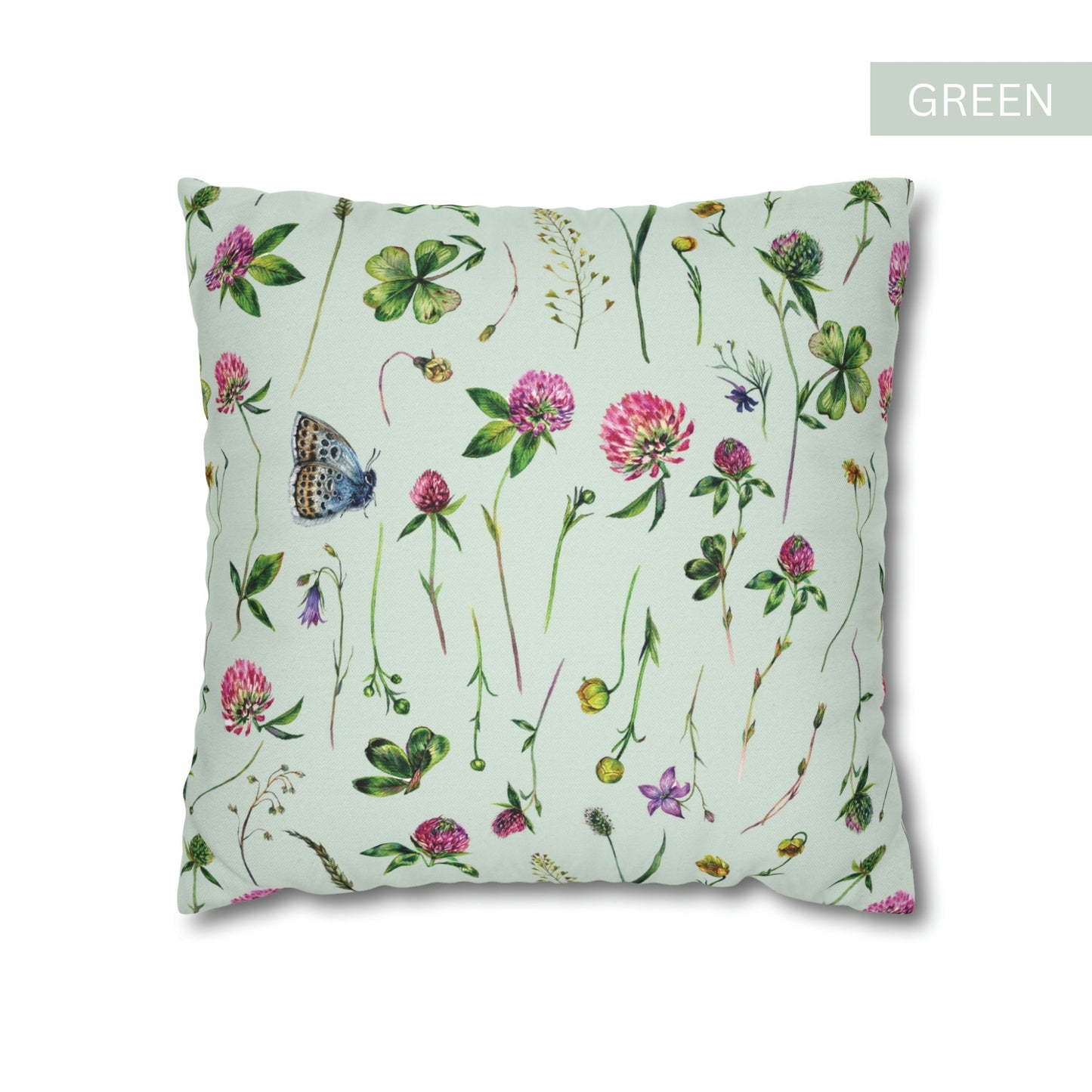 a green pillow with flowers and butterflies on it