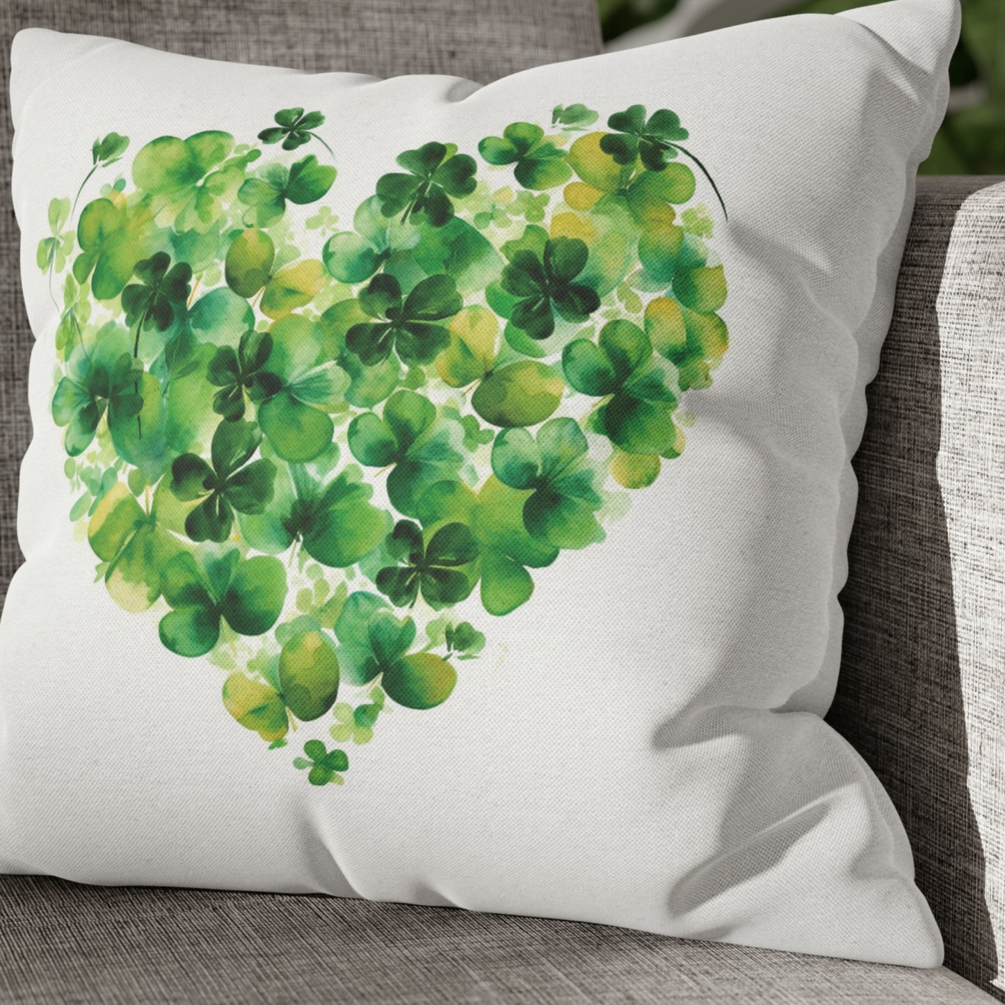 a heart made of green clovers on a white pillow