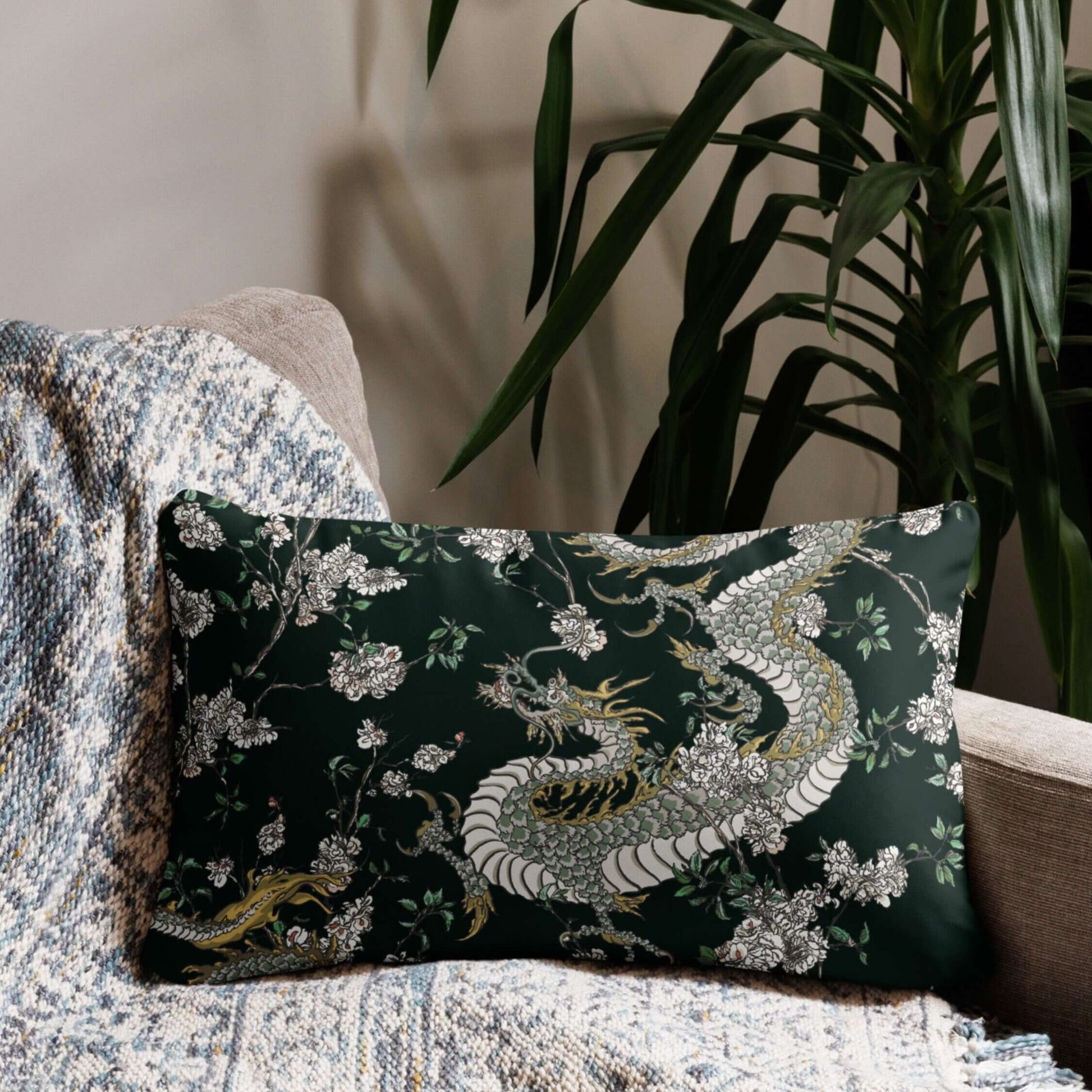 Dragon chinoiserie lumbar pillow on chair. Dark green pillow with oriental design and flowers.