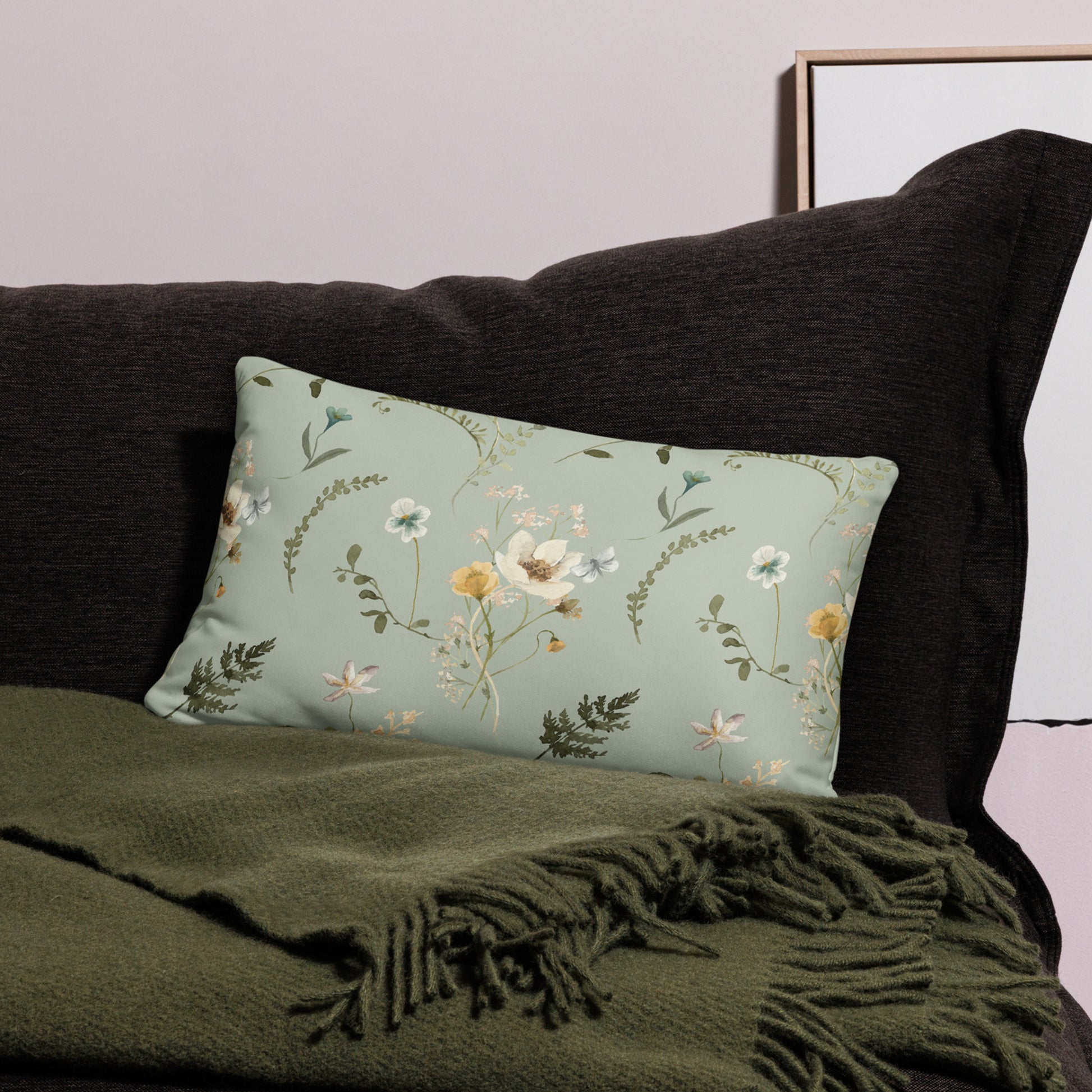 a pillow with flowers on it sitting on a couch