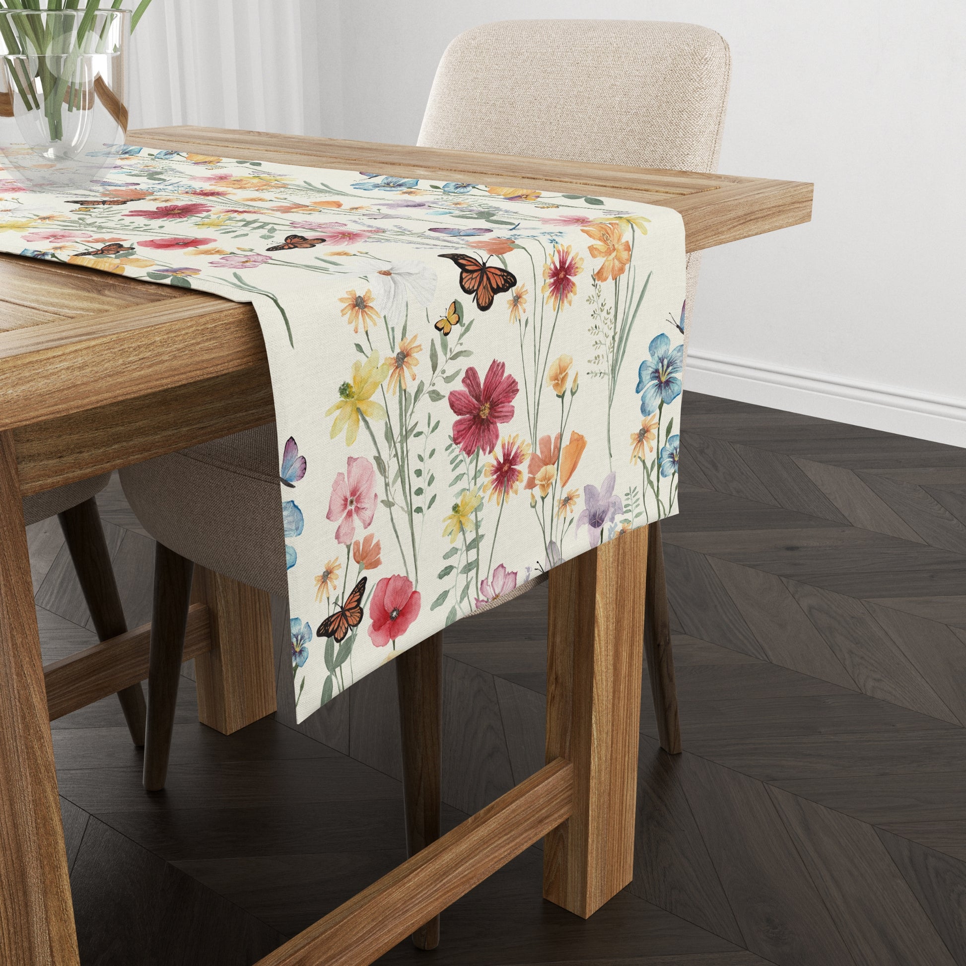 a table with a beautiful botanical table runner with flower vase on it