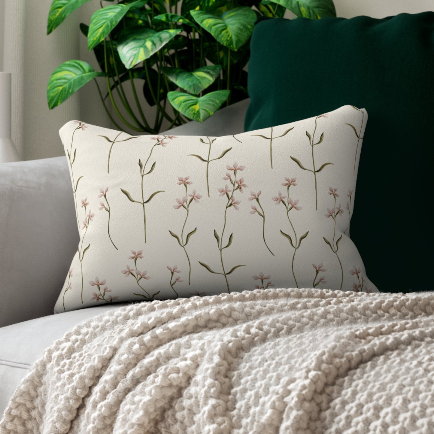 a white couch with a white blanket and a green plant