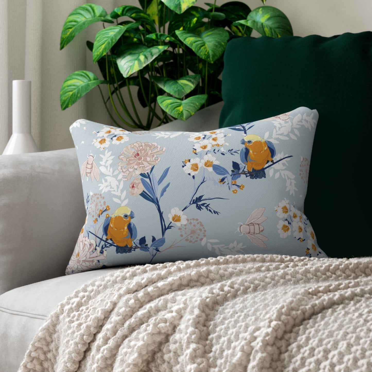 a white couch with a blue and yellow pillow on top of it