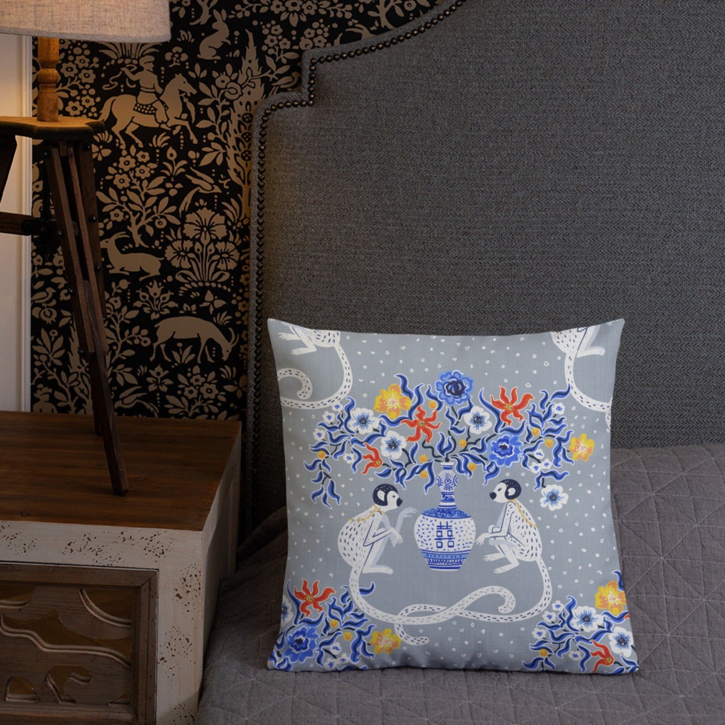 Blue Chinoiserie Monkey Floral Pillow on bed. Oriental design with pagoda vase and monkeys.