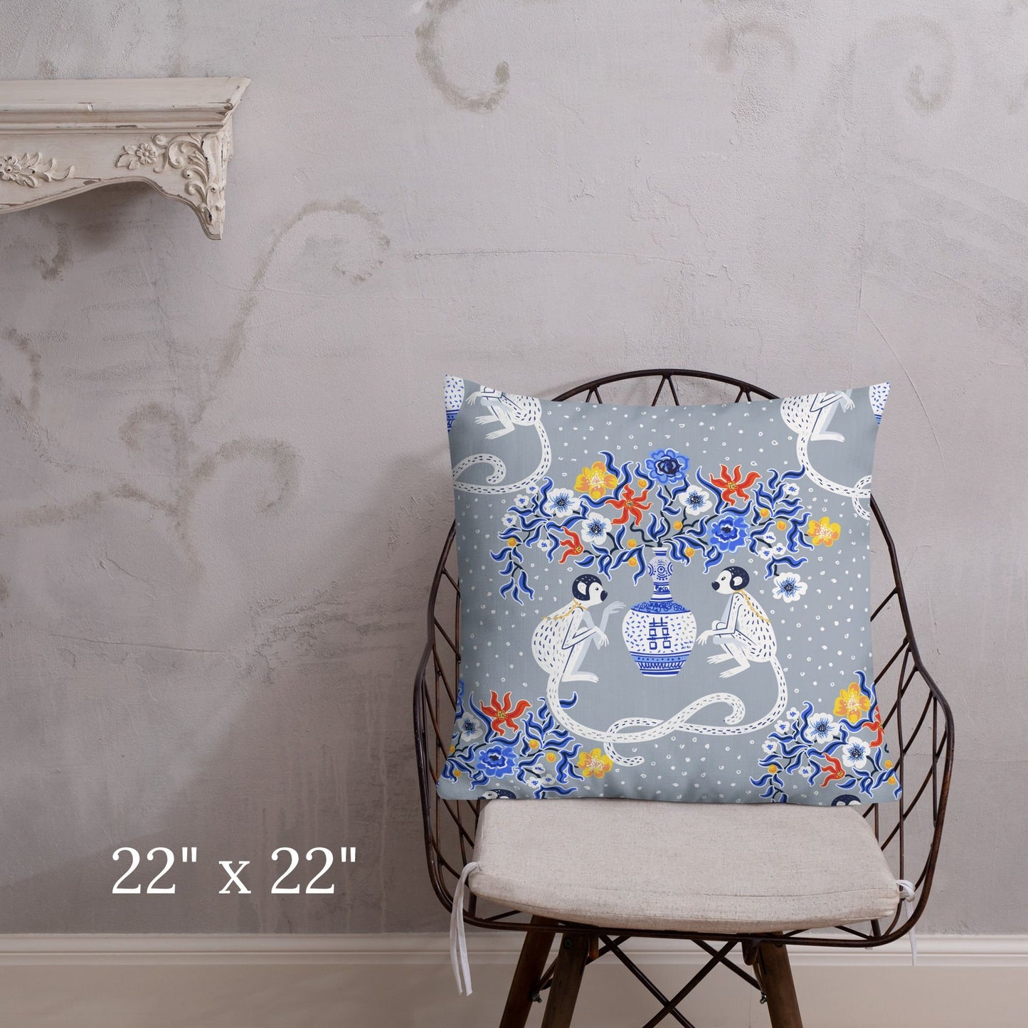 chinoiserie monkey throw pillow on chair. Oriental design with pagoda vase and floral accents.