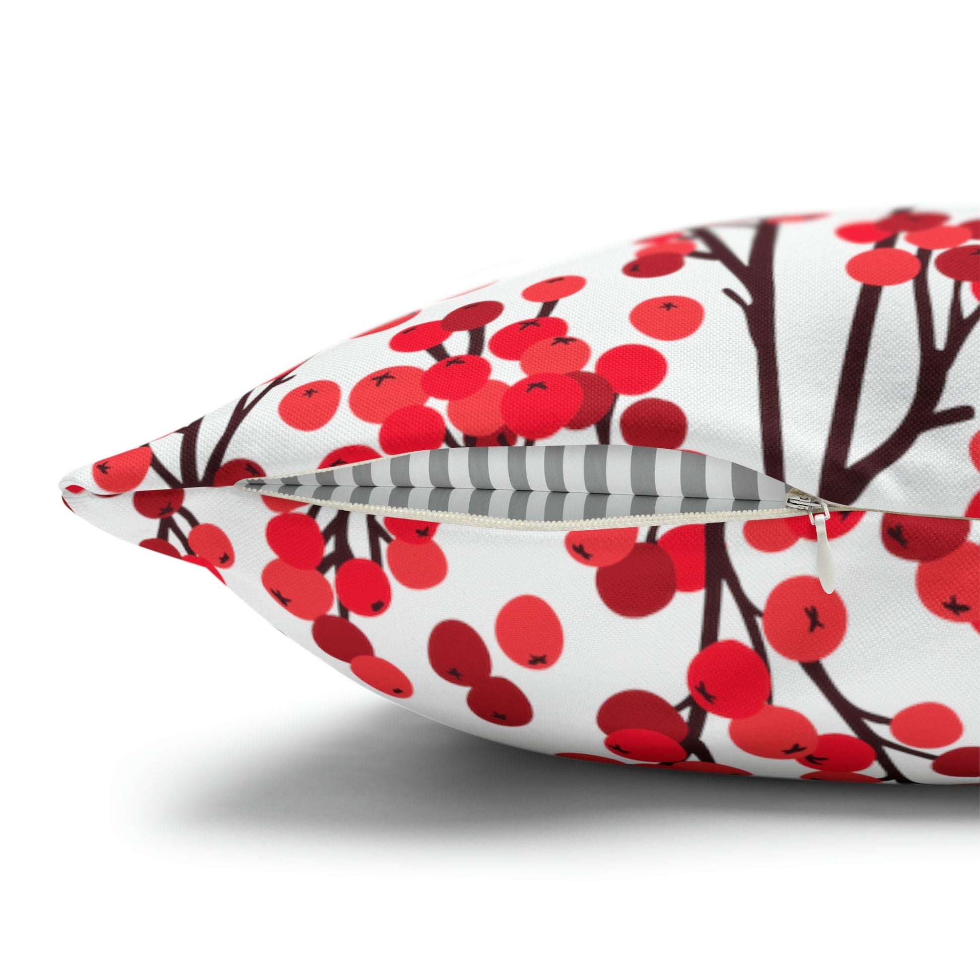 Close-up of red winter berry botanical pillow with zipper detail – festive seasonal decor