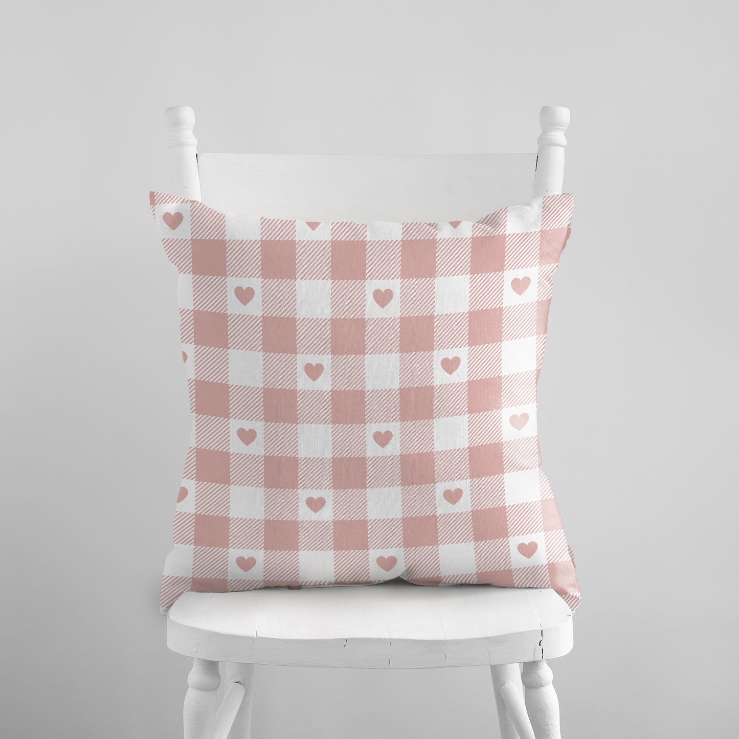 Valentine Pink Gingham Hearts PILLOW on a white chair – soft blush checkered cushion cover.