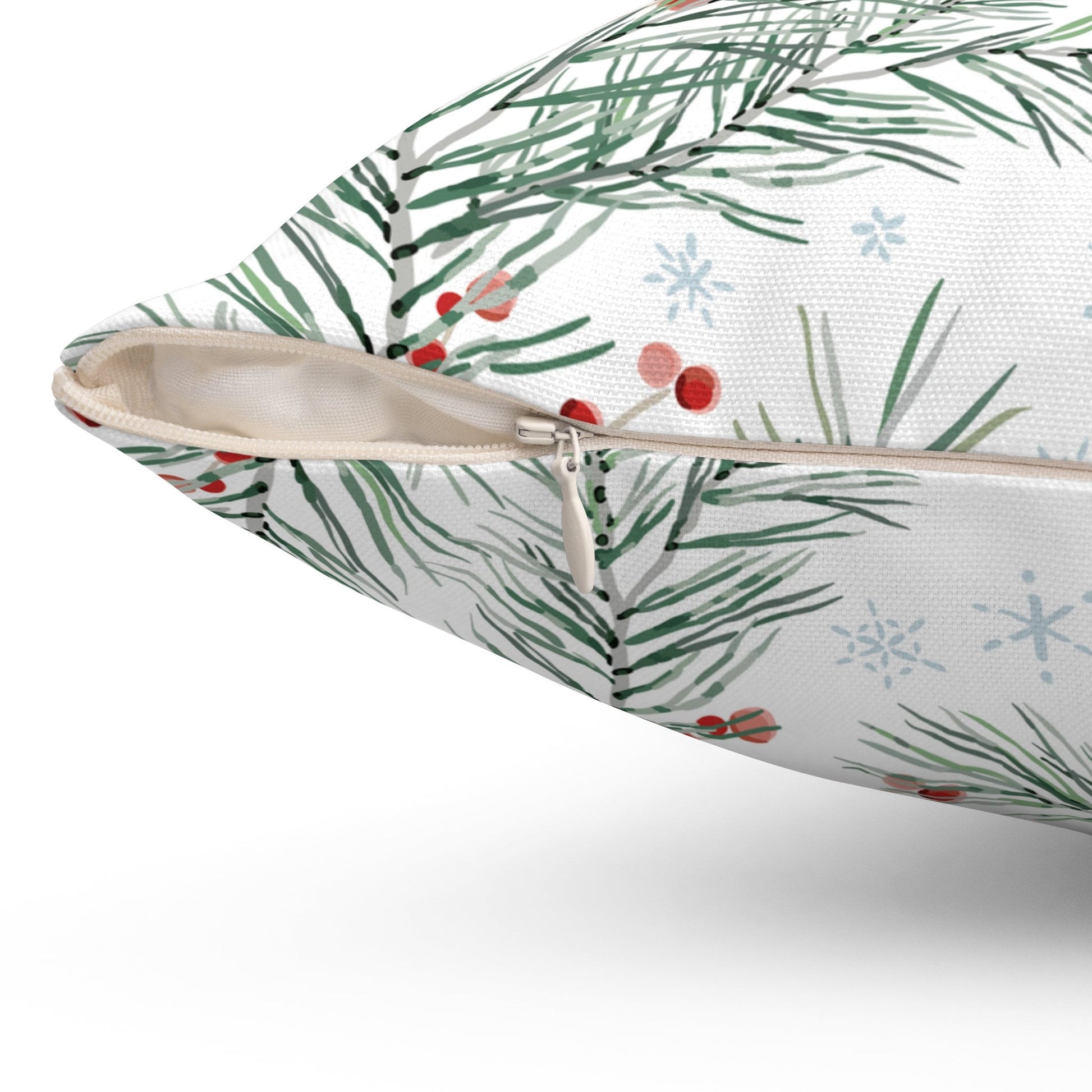 Close-up of watercolor pine and berry Christmas pillow with hidden zipper detail