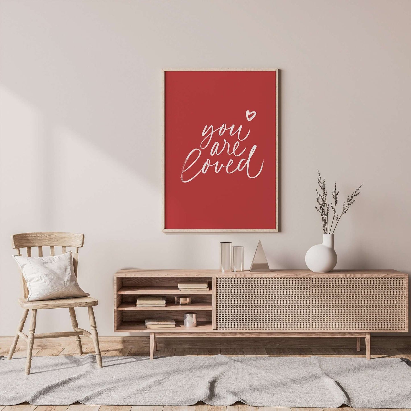 cute minimal living room decorated with "you are loved" red poster hanging on wall